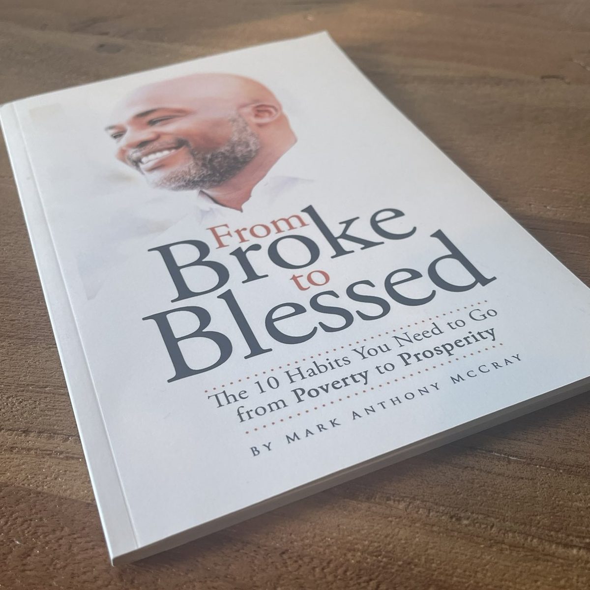 From Broke to Blessed paperback on a wooden surface